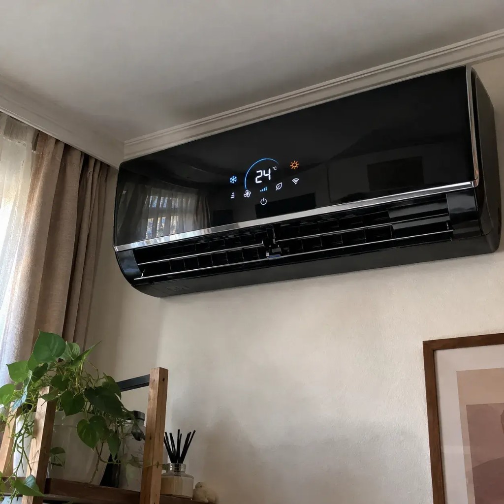 Nextherm glossy black wall unit with digital display mounted in a bright room